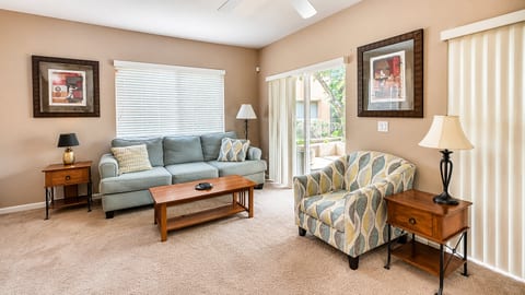 Comfortable living area with cozy seating, natural light, and easy access to the outdoor space.