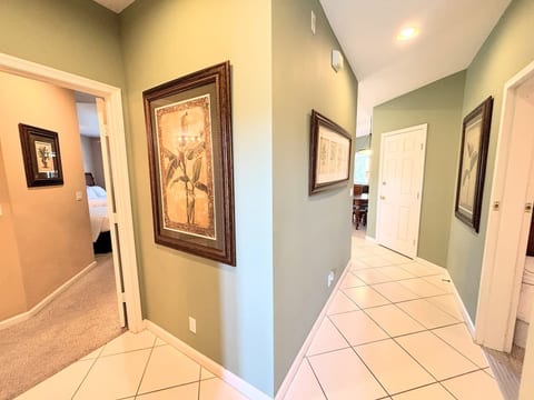 Entry hallway with tile flooring, neutral finishes, and easy access to the main living areas and bedrooms.