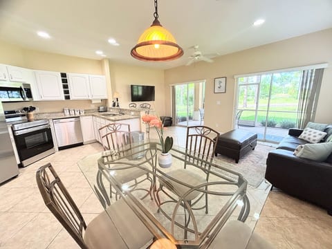 Open-concept living, dining, and kitchen space with stainless steel appliances, granite countertops, and plenty of natural light.