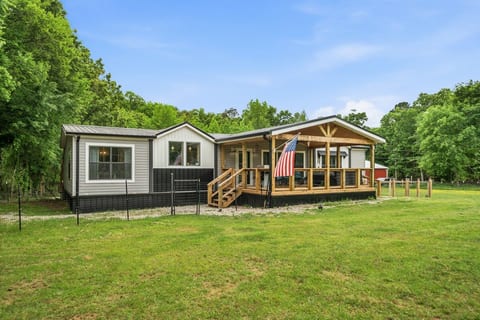 Modern farmhouse with big covered porch and fenced yard retreat