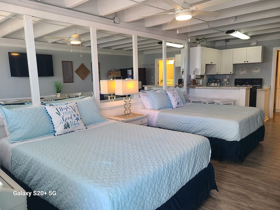 Cozy sleeping area with two comfy queen beds and fresh linens.