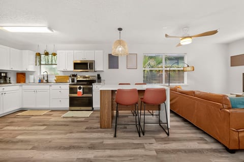 Bright open-plan kitchen and lounge with island seating and modern style