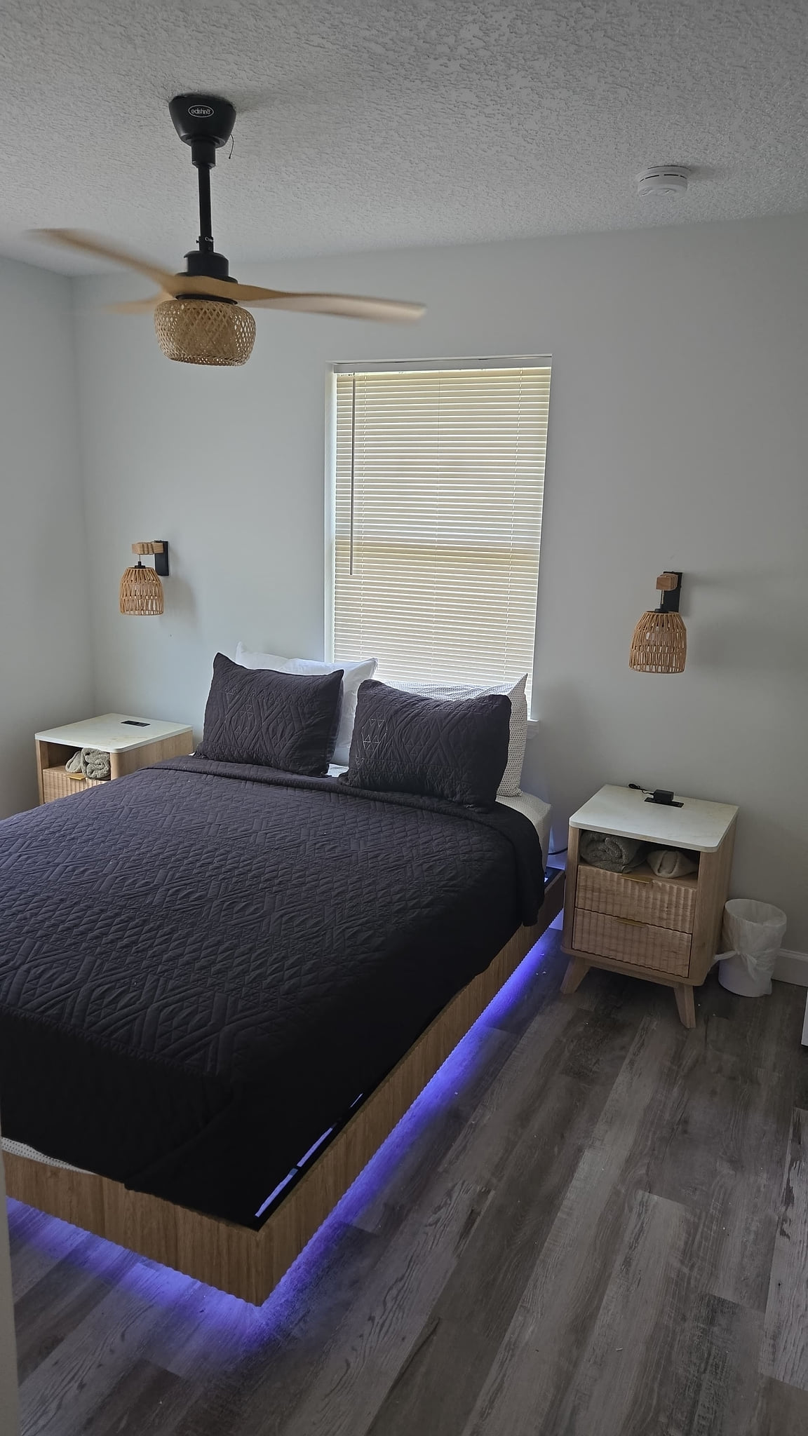 Modern bedroom with ambient LED bed lighting and cozy natural accents