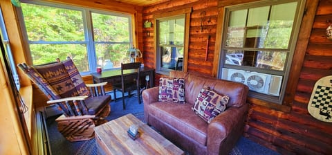 Work remotely or unwind with a good book on this cozy, inviting cabin porch.