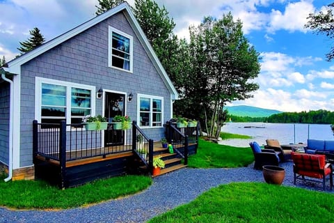 Waterfront cottage with a private fire pit, outdoor seating, and beautiful lake views.