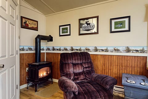 Cozy sitting area with a fireplace and recliner, perfect for relaxing after a day outdoors.