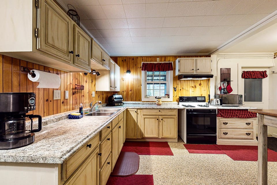Rustic kitchen with granite countertops, full-size appliances, and plenty of space for preparing meals.