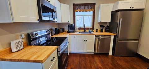 Modern kitchen with stainless steel appliances, spacious countertops, a coffee station, and everything needed to prepare meals during your stay.