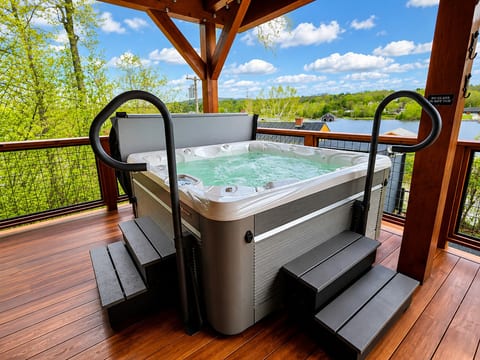 Private covered hot tub with scenic water views, offering the perfect place to relax and unwind while enjoying the beauty of Maine.