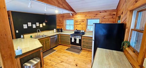 Rustic cabin kitchen with modern appliances, ample counter space, and warm wood finishes for a comfortable stay.