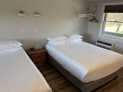 Two queen beds with soft linens, natural light, and a cozy setup for a comfortable stay.