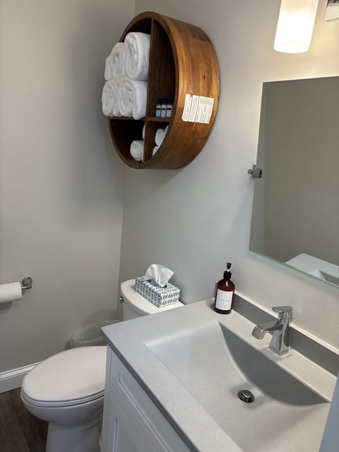 Modern bathroom with fresh towels, premium toiletries, and a clean contemporary design for a comfortable stay.