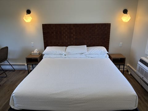 Spacious king bedroom with luxury linens, modern lighting, and a comfortable retreat for a restful stay.