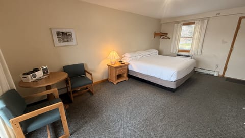 Spacious king bedroom with comfortable seating, a dining area, and plenty of room to relax during your stay.
