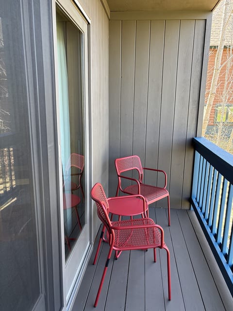 Private balcony with comfortable seating, perfect for enjoying fresh air and a relaxing getaway.