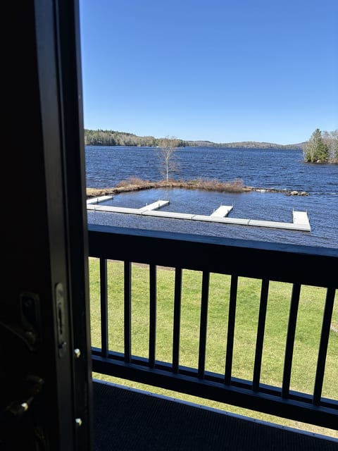Private waterfront balcony overlooking the lake, community docks, and beautiful scenic views.