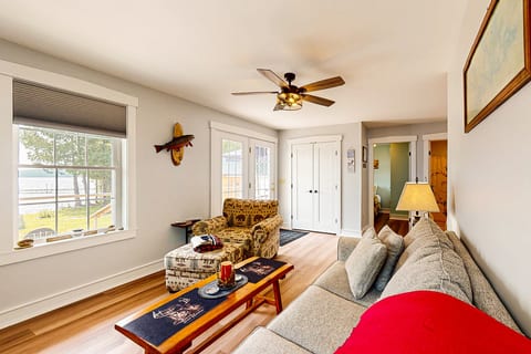 Bright and inviting lakeside living room with comfortable seating, waterfront views, and a relaxing space to gather after a day on the lake.
