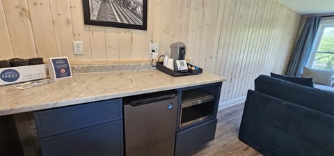 Brew, sip, and savor—Nespresso, fridge, and microwave all within reach.