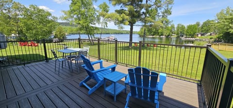 Private waterfront deck with outdoor seating and beautiful lake views.
