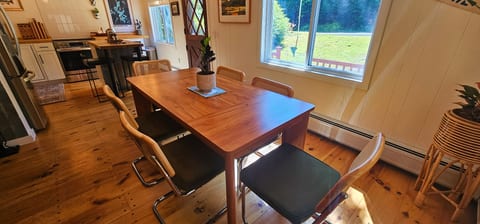 Bright dining area with seating for six and an open-concept kitchen.