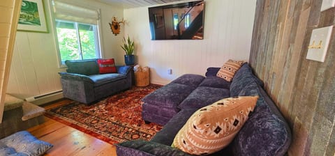 Cozy living area with a large sectional, smart TV, and comfortable seating.