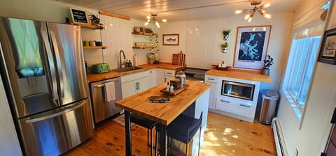 Modern kitchen with stainless steel appliances and a spacious island.