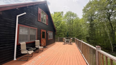 Spacious wraparound deck with outdoor seating, peaceful forest views, and the perfect setting for relaxing cabin getaways.