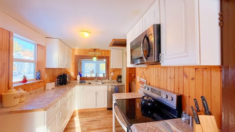Bright farmhouse kitchen with modern appliances, ample counter space, and warm wood accents.