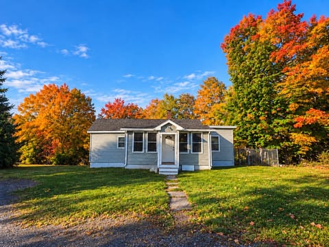 Autumn Cottage Under Blue Skies