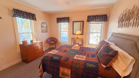 Cozy full bedroom with natural light and warm rustic décor.