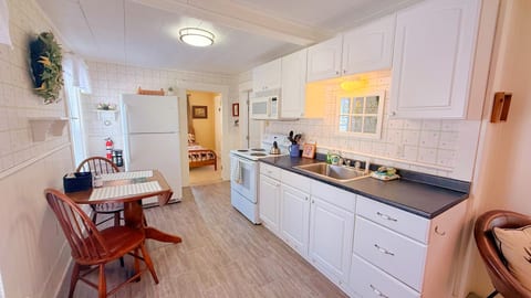Bright kitchen with full appliances and cozy dining space for easy meals and relaxing stays.
