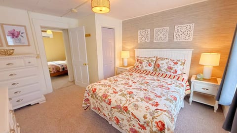 Bright and inviting queen bedroom with elegant décor, cozy bedding, and a peaceful atmosphere designed for a comfortable and relaxing getaway.