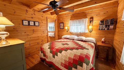 Cozy king bedroom with warm wood interiors and rustic cabin charm.
