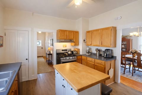 Bright farmhouse kitchen with warm wood cabinetry, a spacious island, and cozy modern charm.