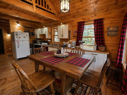 Rustic cabin dining area with cozy wood interiors, full kitchen, and warm lodge-style charm.