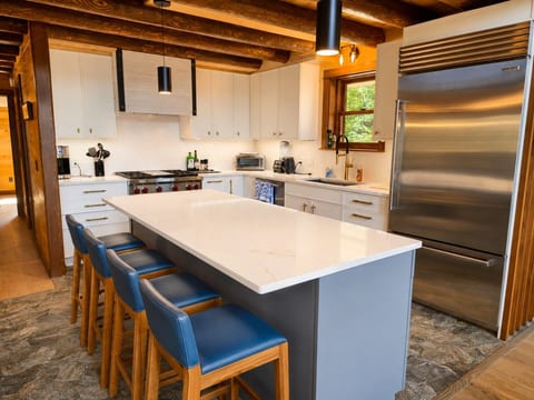 A spacious, fully equipped kitchen with a large island and plenty of seating.