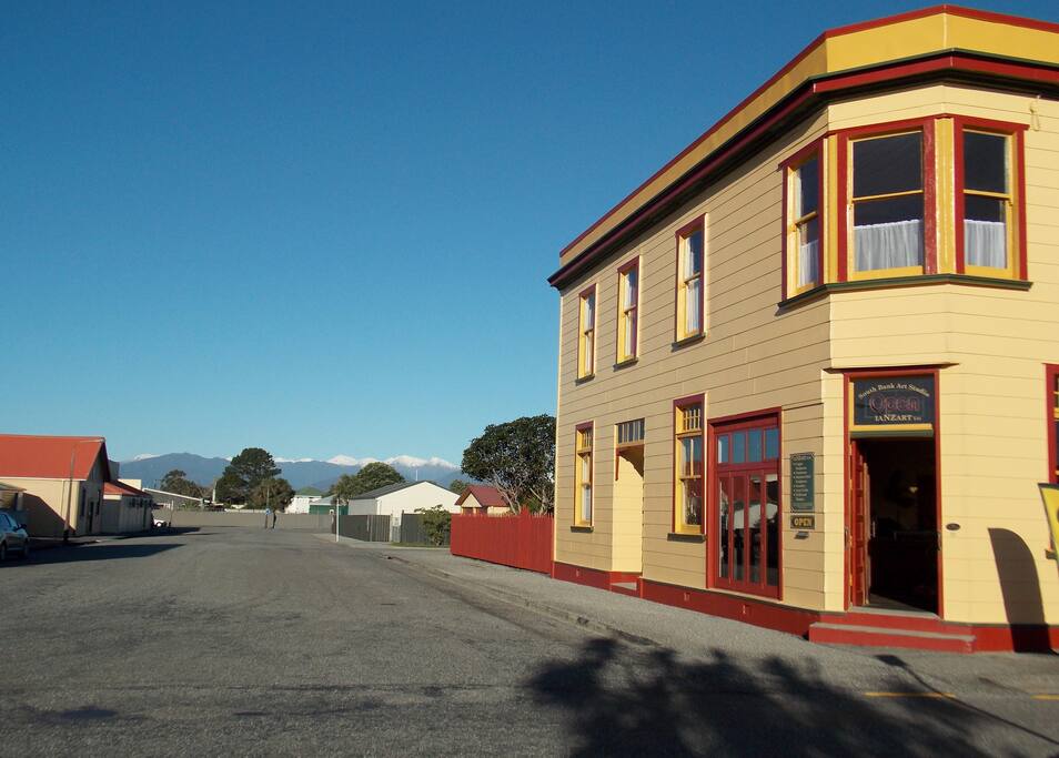 View from the front lawn toward the snow-capped Southern Alps and the copper art gallery.