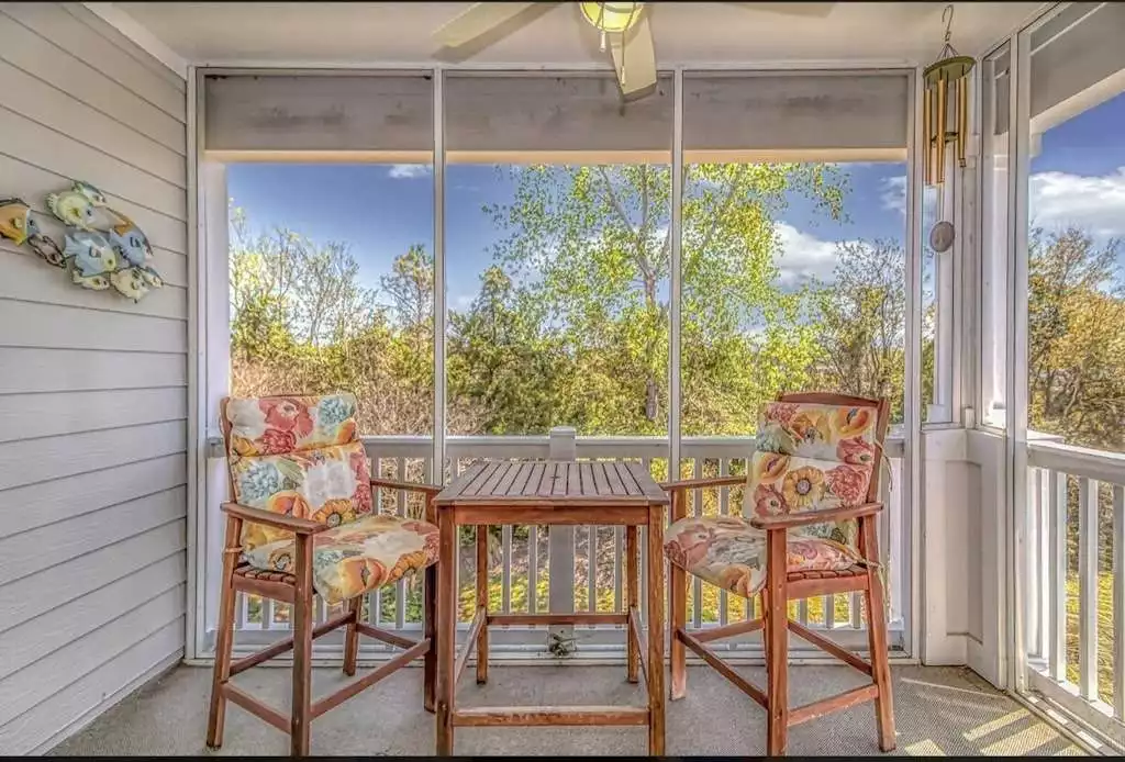 Veranda with Peek-a-Boo views of the Intracoastal Waterway and Norman Golf Course. Enjoy your coffee here in the morning or a drink as the sun sets.  - Oasis at Barefoot Resort - Beach, Golf, Marina - North Myrtle Beach