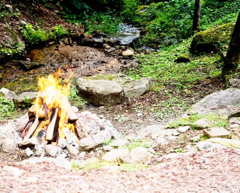 Fire pit beside the hot tub and babbling creek