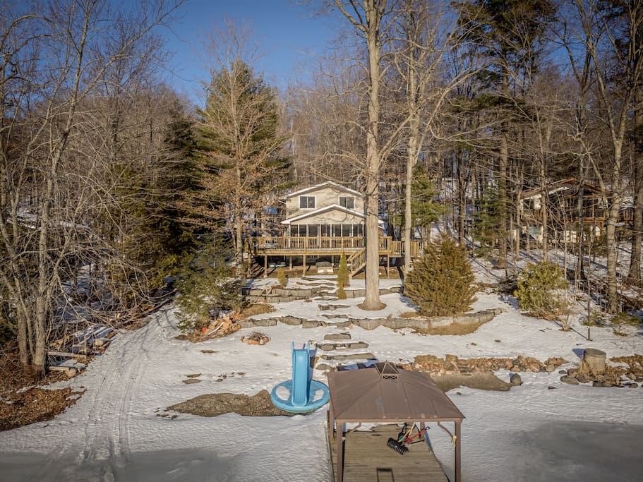 The view of the large and beautiful limestone steps leading up to the house is truly breathtaking. The Lake House, with its spacious deck and inviting atmosphere, is a place of peace and comfort. - Waterfront Cottage Fun! Games, snowmobile, hiking - Tichborne