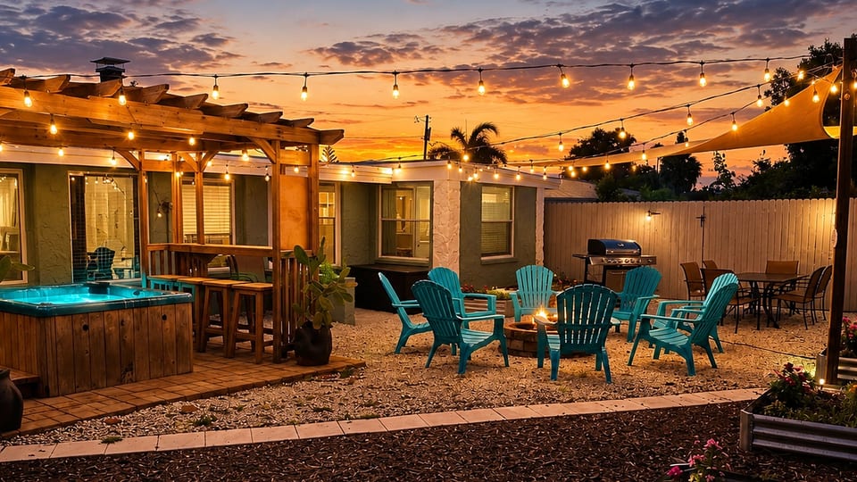Private backyard retreat with hot tub, fire pit & outdoor dining under café lights