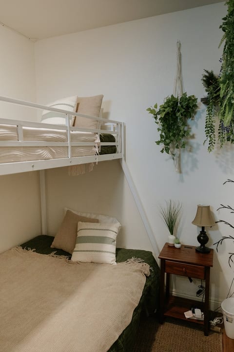 Cozy bunk room with stylish decor, soft neutrals, and space for the whole crew