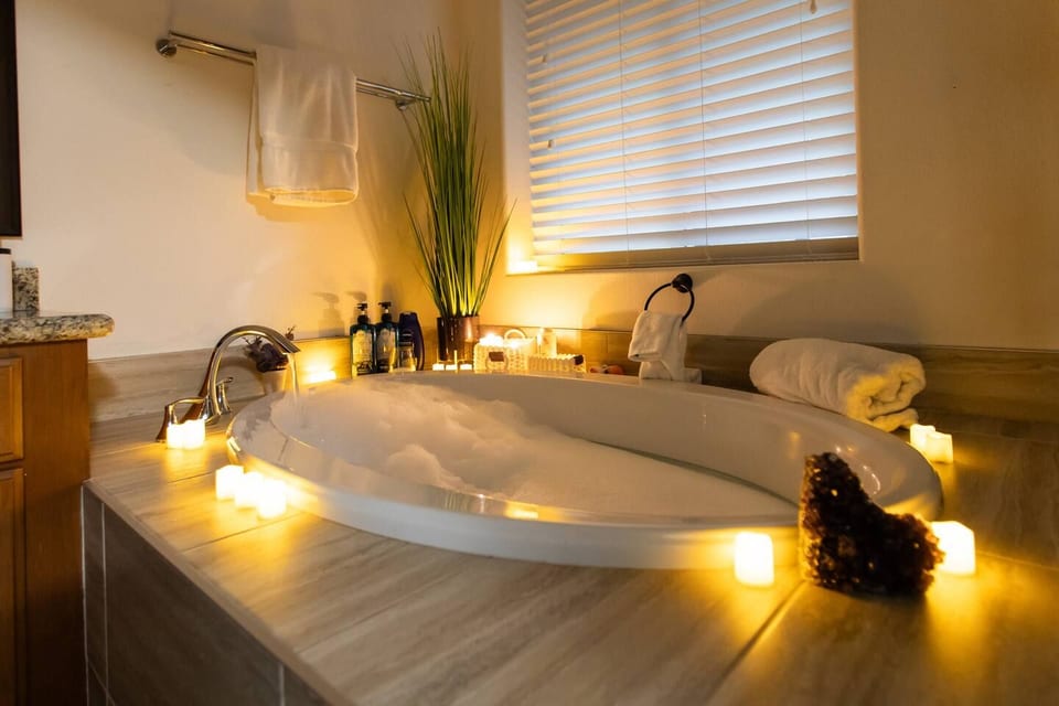 Romantic bubble bath with candlelight and cozy spa vibes