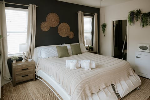 Cozy, design-forward bedroom with natural light and stylish accent wall