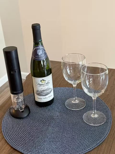 Wine night ready with glasses, opener, and a cozy table setup