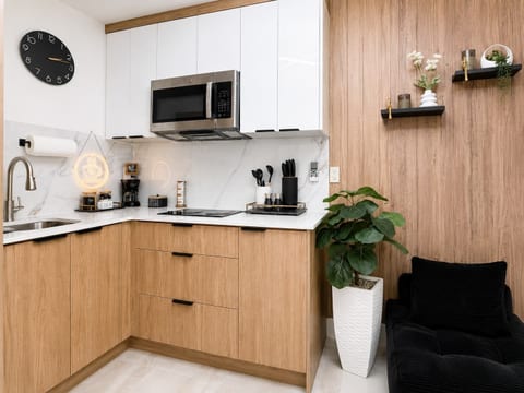 Find inspiration and create delicious meals in a modern, functional setting, meticulously designed to balance productivity with tranquility.