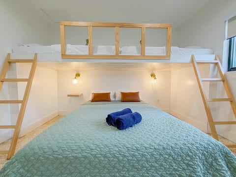 Lofted Bedroom: Experience unique sleeping quarters with stylish decor and warm lighting!