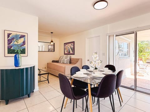 Dine in style in Oakland Park—featuring a modern table, plush chairs & bright natural light.