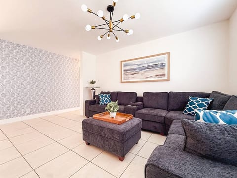 Relax in this chic living room with a plush sectional & coastal décor vibes.