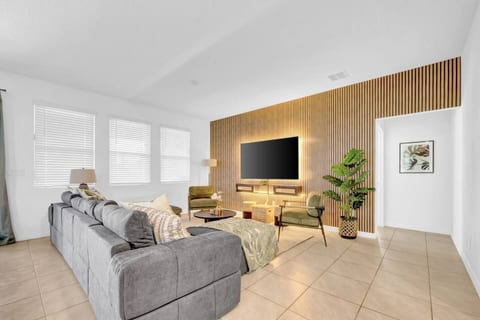 Cozy vibes await in the living room—sink into comfort, enjoy the glowing ambiance, and binge your favorites on the big-screen TV. The perfect spot to unwind!